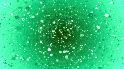 Wall Mural - Shiny particles radiate from the center of a 4K motion loop green background.