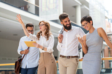 Wall Mural - Happy business people, colleagues in modern office working together and using tablet