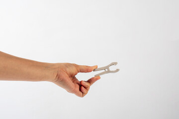 Wall Mural - Close up of clothes peg in hand on white background