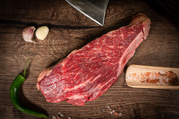 Poster - Raw hanging tender or onglet steak of beef on wooden Board with rosemary and thyme on wooden background