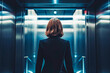 Business woman entering elevator. She will take the elevator to a lower floor for a business meeting.