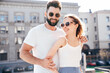 © halayalex - Smiling beautiful woman and her handsome boyfriend. Woman in casual summer clothes. Happy cheerful family. Female having fun. Couple posing in street at sunny day. Having tender moments. In sunglasses