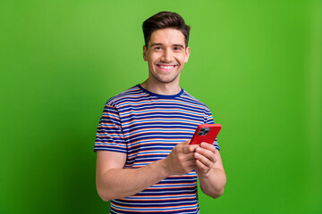 Poster - Portrait of positive nice person hold use smart phone telegram facebook instagram isolated on green color background