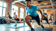 © MP Studio - group of focused individuals engaged in a high-intensity workout, led by a man in the foreground in a dynamic lunging position