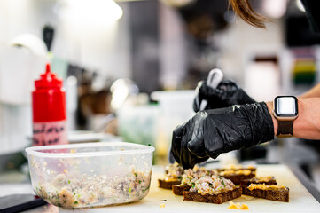 Wall Mural - Professional chef cooking forshmak of herring with black bread in restaurant kitchen