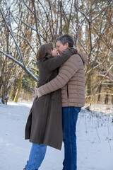 Wall Mural - happy couple in winter snowy park