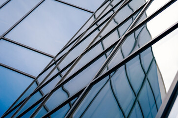 reflection with distortion in the window of a modern tall building