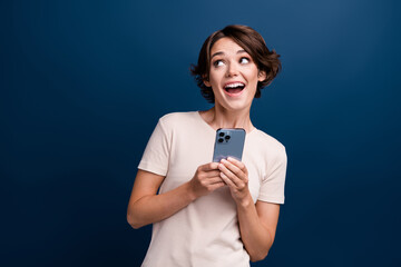 Sticker - Photo portrait of attractive young woman hold device look empty space dressed stylish white clothes isolated on dark blue color background