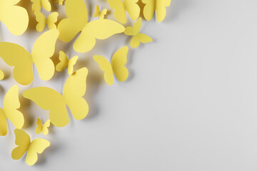 Wall Mural - Yellow paper butterflies on white background, top view. Space for text