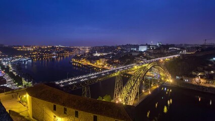 Wall Mural - Day to night transition aerial panoramic view of the historic city of Porto, Portugal timelapse with the Dom Luiz bridge. Colorful sky after sunset