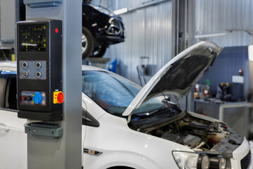 Sticker - Double-column lift with top synchronization. Lift lift control system for cars in a car service station.