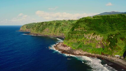 Wall Mural - Aerial shot, drone point of view picturesque landscape view green mountains surrounded by the Atlantic Ocean. Sunny summer day. San Miguel Island, Azores, Portugal