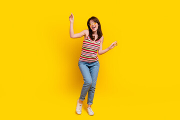 Wall Mural - Full size photo of lovely woman dressed knitwear top jeans pants in sunglass dancing look empty space isolated on yellow color background