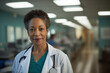 Portrait of a confident black female doctor in her 50s posing with a confident and warm expression in hospital wearing medical coat.