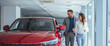 © Dragana Gordic - Portrait of a beautiful young couple choosing a new car at a car dealership. Buying a long-awaited car. Couple buying the car. Pair in a car salon. Husband with vife choose the automobile