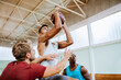© Marko Geber - Young men playing basketball indoors