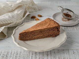 chocolate cake with cocoa on a wooden background