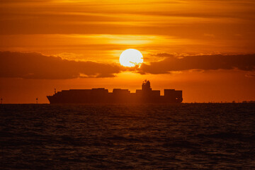 Scenic view of a ship in the sea at sunset