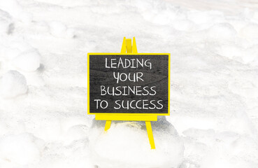 Wall Mural - Leading your business to success symbol. Concept words Leading your business to success on beautiful blackboard. Beautiful snow background. Leading your business to success concept. Copy space
