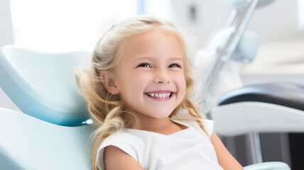 Wall Mural - Happy little blonde girl in dentist chair looking satisfied with treatment, on the background of blurred doctor's office. Children's dentistry, routine checkup, no fear of treatment and pain