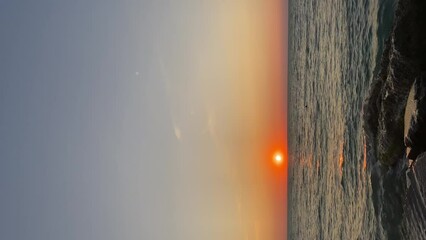 Wall Mural - Summer sunset seascape. Sea and golden sunset. Vertical video.