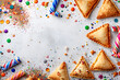 Festive Purim background, Purim attributes, triangular pies, Haman ears, traditional hamantaschen cookies. Postcard on a grey background.
