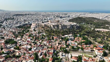 Wall Mural - Aerial drone cinematic video above unique Acropolis hill and old historic Plaka district, Athens historic centre, Attica, Greece