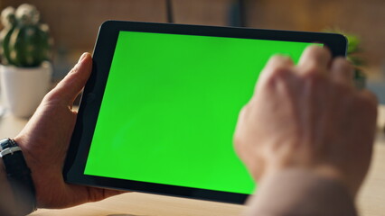 Wall Mural - unknown businessman scrolling chroma key tablet working online at office closeup