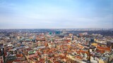 Fototapeta Miasto - Aerial view of Poznan's historic market square in winter, showcasing the charming old townhouses adjacent to the square. The drone captures the city's architectural heritage under a winter sky.