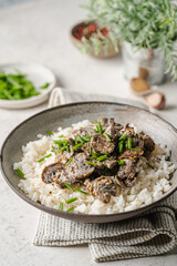 Poster - Risotto with mushrooms and herbs on white marble background.