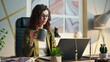 © stockbusters - Business woman holding coffee sitting office desk close up. Girl looking laptop.