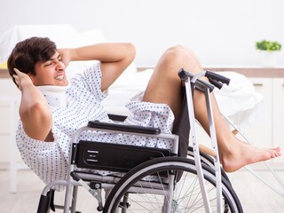 Wall Mural - Young handsome man in wheelchair at the hospital