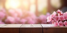 Blurry Pink Sakura Flower Background With Wood Table Top For Displaying Or Product Montages.