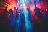 Young people dancing and having fun in a nightclub during a music festival. Crowd at concert