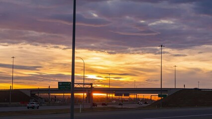 Wall Mural - road in a city in sunrise colorful morning with beautiful cloudscape background. time lapse vehicles