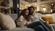 © Muriel - Funny photograph of a smiling or laughing couple relaxing on a couch on display in a furniture store, testing the sofa they forgot they are not at home, customers enjoying this shopping experience