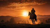 Fototapeta Konie - A lone cowboy and his trusty steed, silhouetted against the fiery orange hues of a desert sunset.