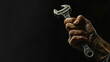 Close up realistic picture of a hand holding a wrench isolated on black