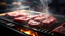  Meat Being Cooked On A Grill With Smoke Coming Out Of The Top Of The Grill And On The Bottom Of The Grill.