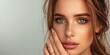 © piai - A gorgeous slightly smiling young woman wearing a ring on a hand touching chin