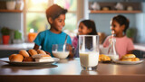 Fototapeta Nowy Jork - Cute little children having breakfast in kitchen at home, focus on milk