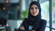 © sderbane - A successful Muslim businesswoman in a hijab, portraying leadership and professional motivation, set against an office backdrop.