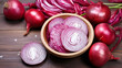 Red onion in whole and cut over a wooden table.