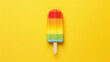 Multicolor cold summer fruit popsicles isolated on a yellow color background