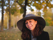 Beautiful smiling elegant woman in big hat smiling portrait