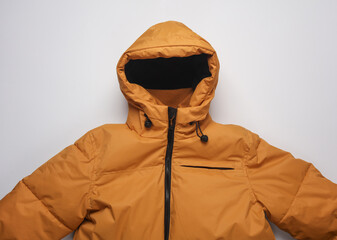 Sticker - Yellow winter down jacket with hood on a white background