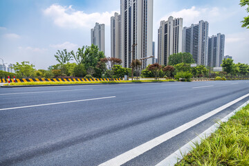 Wall Mural - Empty asphalt road and cityscape background