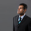 © Image Smith - Happy Indian businessman looking upwards.