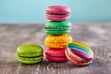 Wall Mural - A bright and colorful assortment of macarons artfully arranged on gray concrete to create an enticing display