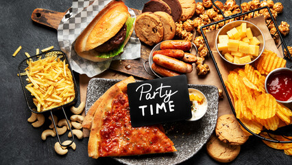 Wall Mural - Fast food on a dark background. Junk food for your heart and skin. Trans fat concept